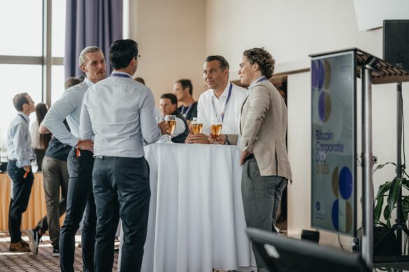 Bitcoiners networking at tables at BTC Prague 2026