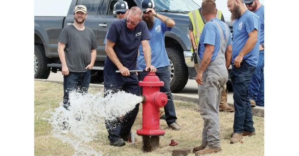 Workers at a fire hydrant in El Reno after a 3 million gallon leak